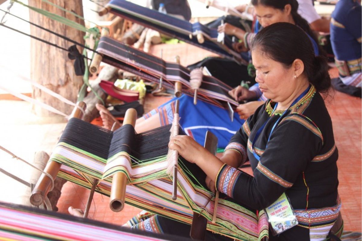 Des artisans ethniques tissent le tissu de brocart
